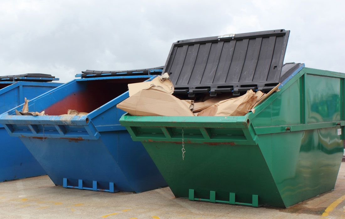 Blue and Green Rear load roll off dumpsters